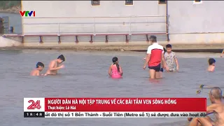 Người dân Hà Nội đổ ra các bãi tắm ven sông Hồng | VTV24