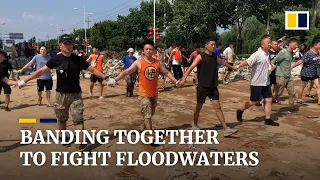 Thousands of residents in central China's Xinxiang city band together to fight rising floodwaters