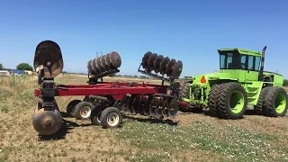 Steiger Bearcat III pulling 24FT folding disk