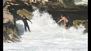 Lifeguard Aaron Buchan helping boy washed onto rocks at Tamarama Beach