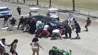 Good Samaritans Race to Lift Car off Motorcyclist