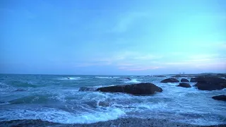 Relaxing sound of crashing waves . Blue Sky and water.