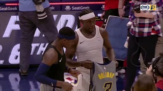 Aaron Holiday and brother Jrue Holiday exchange jerseys after game