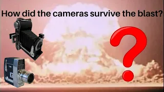 How did the cameras that recorded footage of nuclear tests not get destroyed?