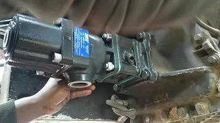 Man single handedly installs side tipper hydraulic wet kit on a UD 410