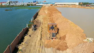 OPERATIONS MACHINERY, DOZER KOMATSU MINI PUSH SOIL AND GRAVEL INTO WATER