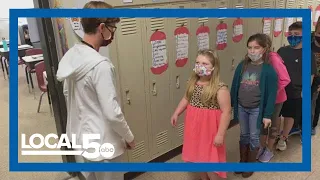 Iowa elementary school teacher greets students with custom handshakes