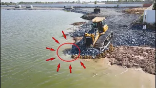 Big Stone skill operator Bulldozer pushing stone into water build new road