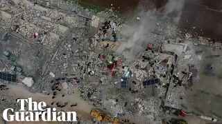 Syria: rescue operations search for survivors in mountain of rubble