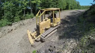Cutting in driveway drainage with bulldozer