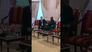 Putin beamingly holding hands with South African President Ramaphosa