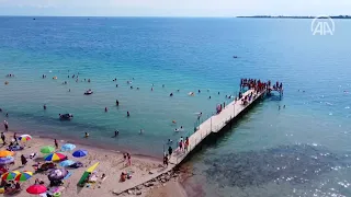 Warm water of Kyrgyzstan's Issyk-Kul lake captivates tourists