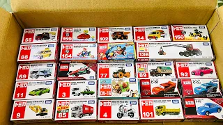 Box full of various miniature cars Peugeot, Volvo, Renault, Hyundai, Pagani, Cadillac One, DHL