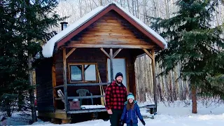 Father and daughter hike into remote OFF GRID CABIN