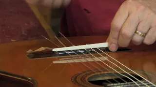 Adjustable saddle for classical guitar