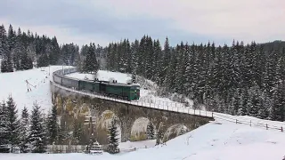 A brutal diesel locomotive rushes from a mountain pass along the old Austro-Hungarian viaduct