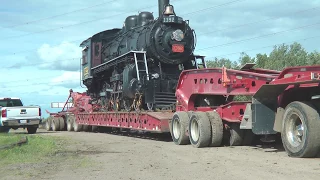 ARM loco 1392 is loaded onto a transport truck for the trip to Stettler