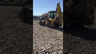 New Holland buldoexcavator backhoe in action Construction machinery