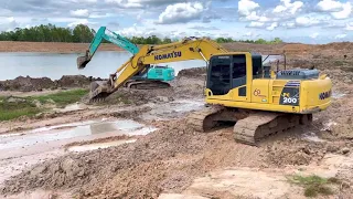 Komatsu Pc200-8M0 and Kobelco Sk200-10 are helping to dredge an old pool.