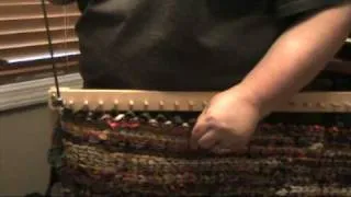 How to remove a finished twined rug from a peg loom.