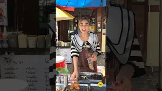 Ploysai Helps Her Friend in A Nearby Shop Sell Grilled Pork.