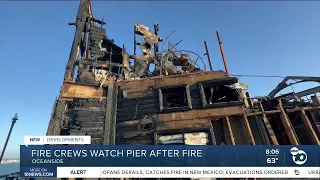 Firefighters watch Oceanside Pier after fire