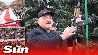 Belarus president brandishes assault rifle as thousands protest outside his residence