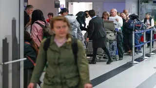 Travelers see long wait times at U.S. airports amid coronavirus travel ban
