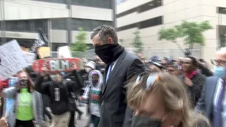 U.S. protesters swarm former Minneapolis police officer with shouts of 'Murderer'