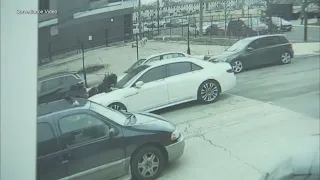 Suspect clings to hood of getaway car as theft crew flees cops