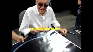 Stan Lee signing The Avengers poster at the Comikaze Expo in 2012