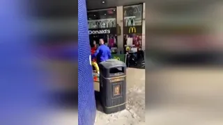 Bizarre footage shows clown outside McDonald's sparring with umbrella-wielding attacker