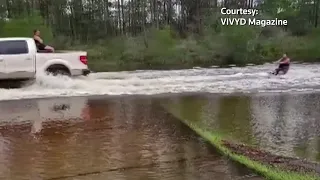 Kneeboarder in Florida rides through flooded streets