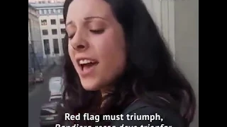 Woman on accordion sings Bandiera Rossa on balcony