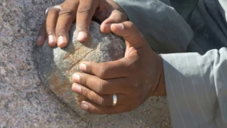 Grinding granite with a dolerite stone ball at the Unfinished Obelisk in Aswan, Egypt.