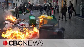 Violent protests in France as president signs bill to reform retirement age