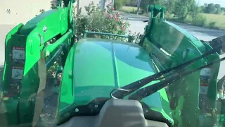 John Deere 5125R ripping shrub out of the ground