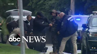 Nearly a dozen armed men arrested in police standoff