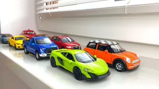 Diecast model cars moving by hand on the windowsill