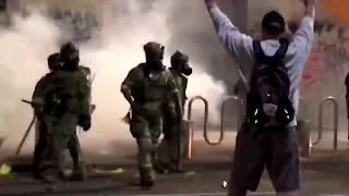 WARNING: GRAPHIC CONTENT - U.S. riot police use tear gas, hit Portland protester with batons