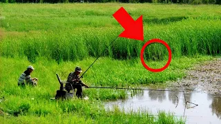 While these men were fishing, a mysterious creature unexpectedly emerged from the tall grass towards