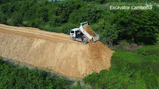 Beautiful Mini Dump Truck Unloading Dirt Into Slope And Small Bulldozer Pushing Building New Dam