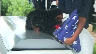 Fallen soldier's widow kisses casket at burial