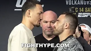 MAX HOLLOWAY TOWERS OVER ALEXANDER VOLKANOVSKI; STARES HIM DOWN, LITERALLY, AT FACE OFF