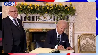 US President Joe Biden signs the visitor's book at Áras an Uachtaráin