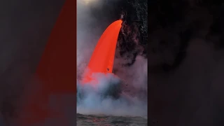 Lava cascading into ocean