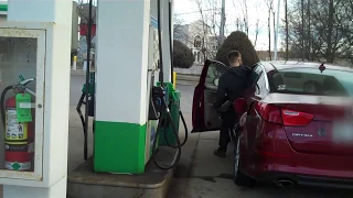 Fat guy pumping gas in thong