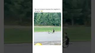 Little boy tries to impress a little girl with his bicycle skills.