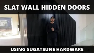 Hidden slat wall doors with SUGATSUNE hinges and push latch.