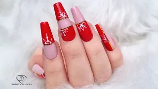 Red and nude Christmas nails with snowflakes. Elegant Christmas nail design.